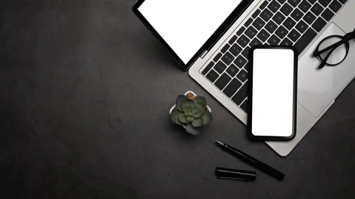 Modern workspace with laptop and phone